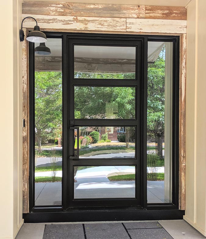 Contemporary custom four panel iron entry with 2” styles & rails, single lite sidelights, clear glass black finish, Patented Thermal Break